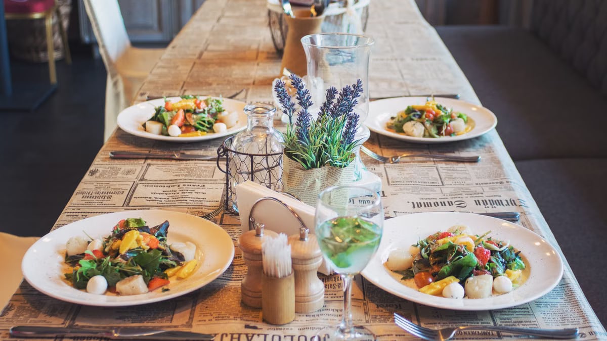 A beautifully arranged table with fresh salads, perfect for a restaurant or café setting.